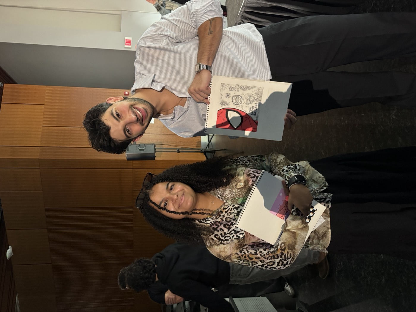 Omar alongside a fan holding the artwork